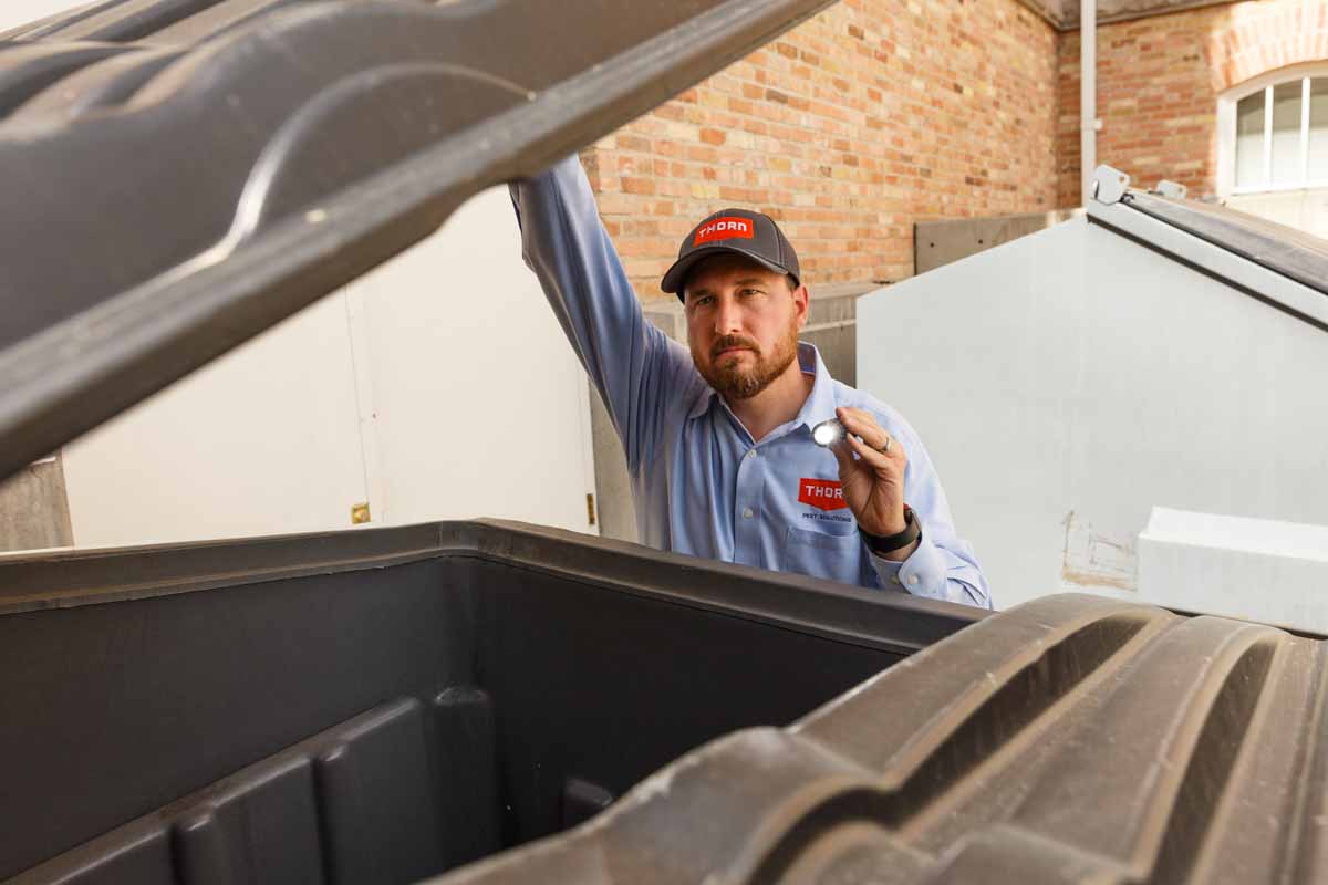 Thorn in Utah inspecting a dumpster for sources of odors.